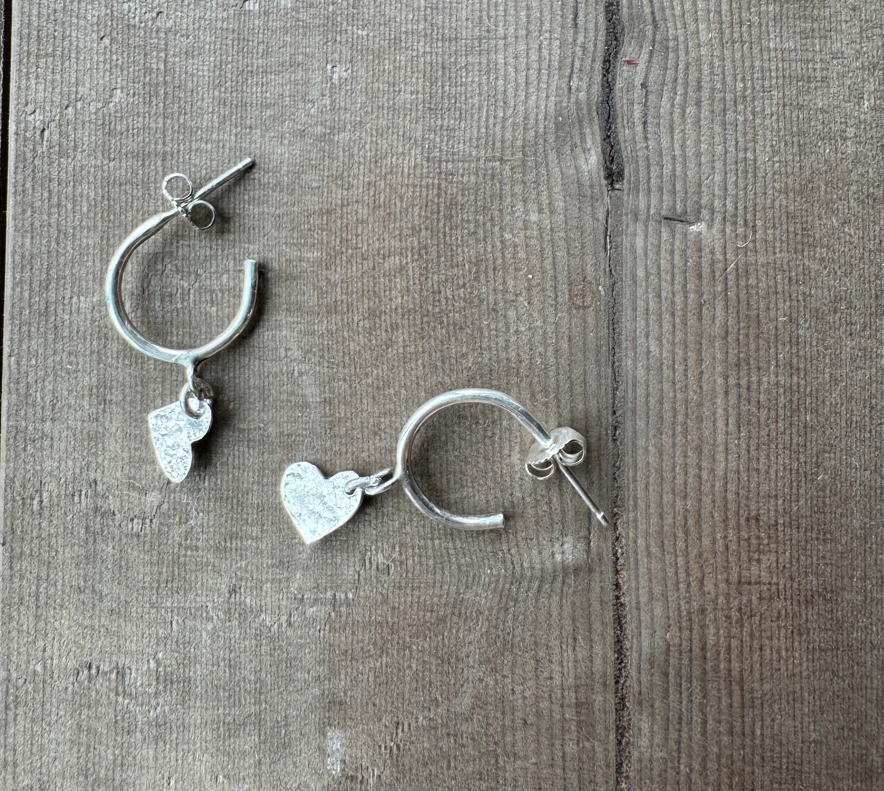 Sterling silver hoops with heart charm. Artisan made. Made by hand in Canada on Vancouver Island