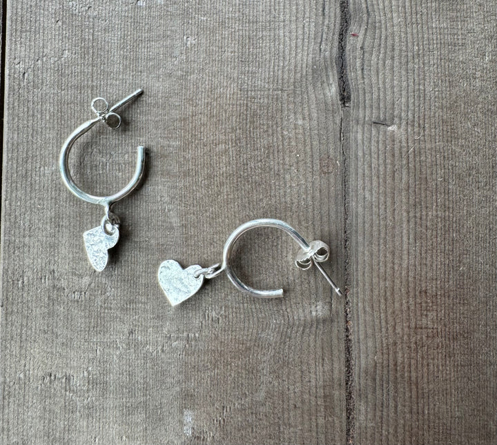 Sterling silver hoops with heart charm. Artisan made. Made by hand in Canada on Vancouver Island