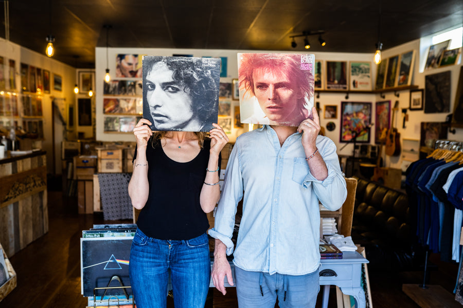 store view people holding vinyl records