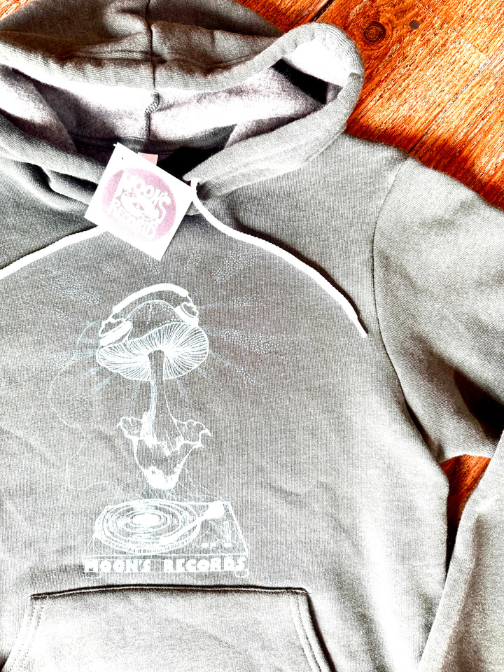 Gray hoodie with a mushroom and record design, branded 'Mushroom Records', on a wooden surface.