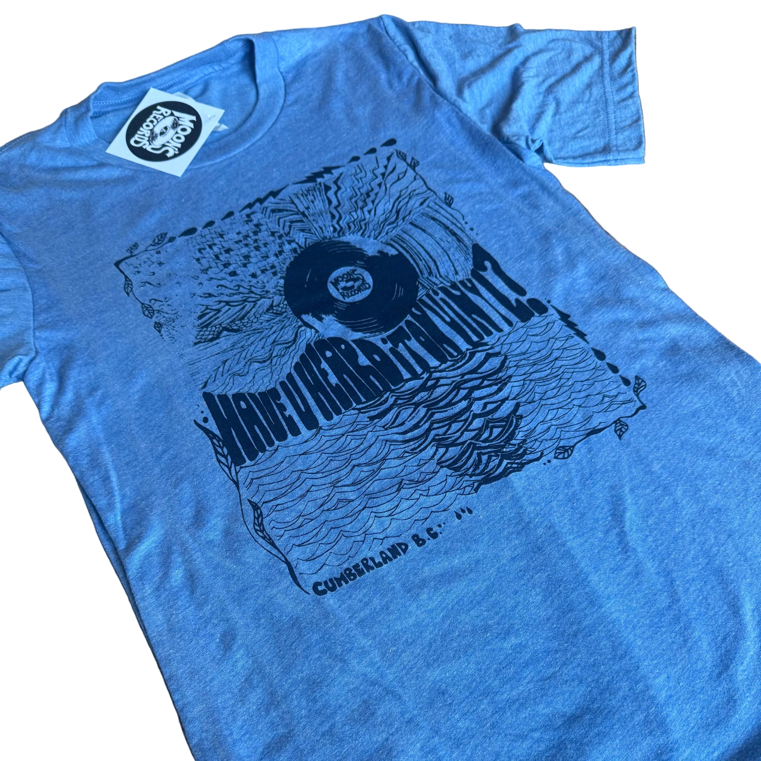 Blue t-shirt with graphic design on a wooden surface