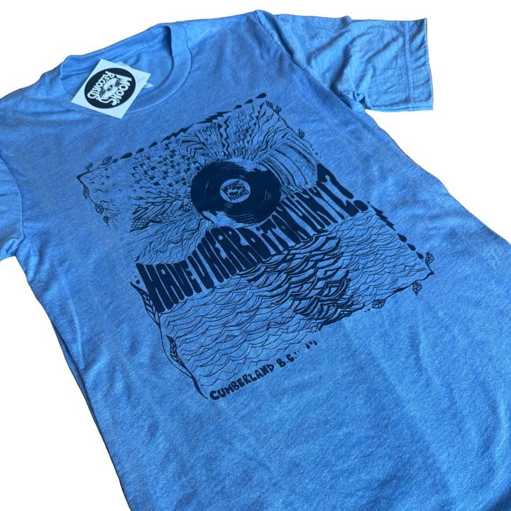 Blue t-shirt with graphic design on a wooden surface
